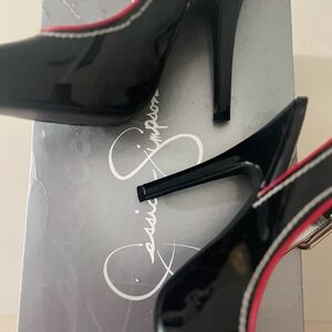 Jessica Simpson Paton leather black heels. 7.5 red trim buckled strap back